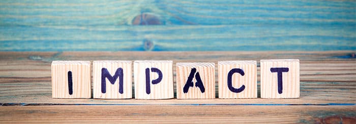 Stem-Cell-Therapy-for-the-Spine Wooden letter blocks spell 'IMPACT' on a rustic wooden table.